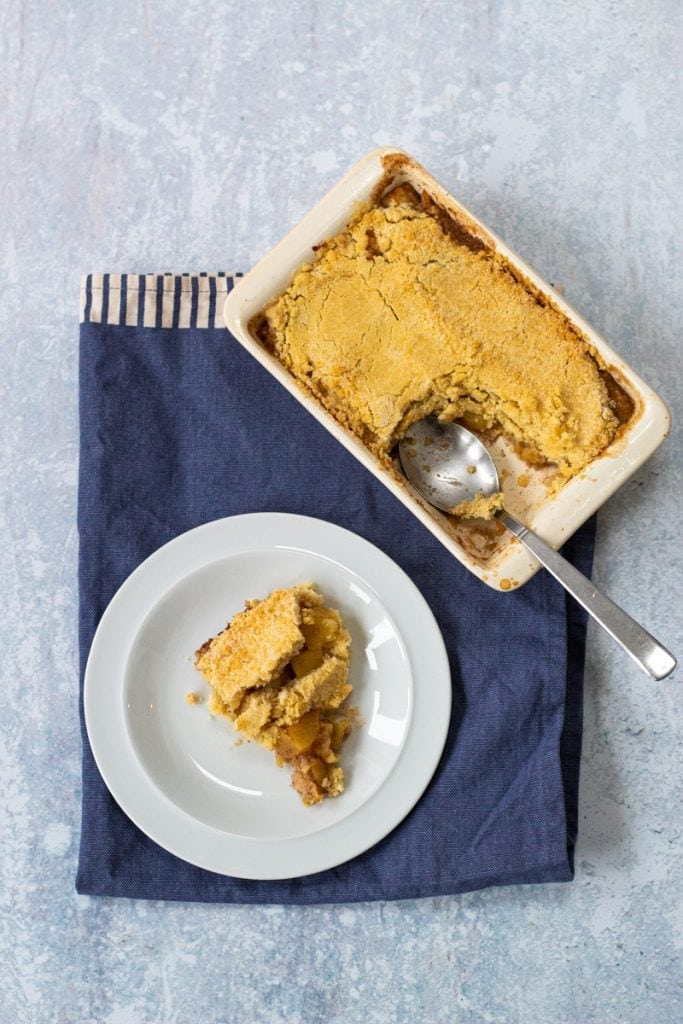 Dish of apple crumble and plate of apple crumble