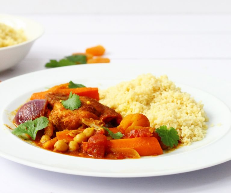 Plate of chicken tagine with chickpeas, carrots, red onions and apricots