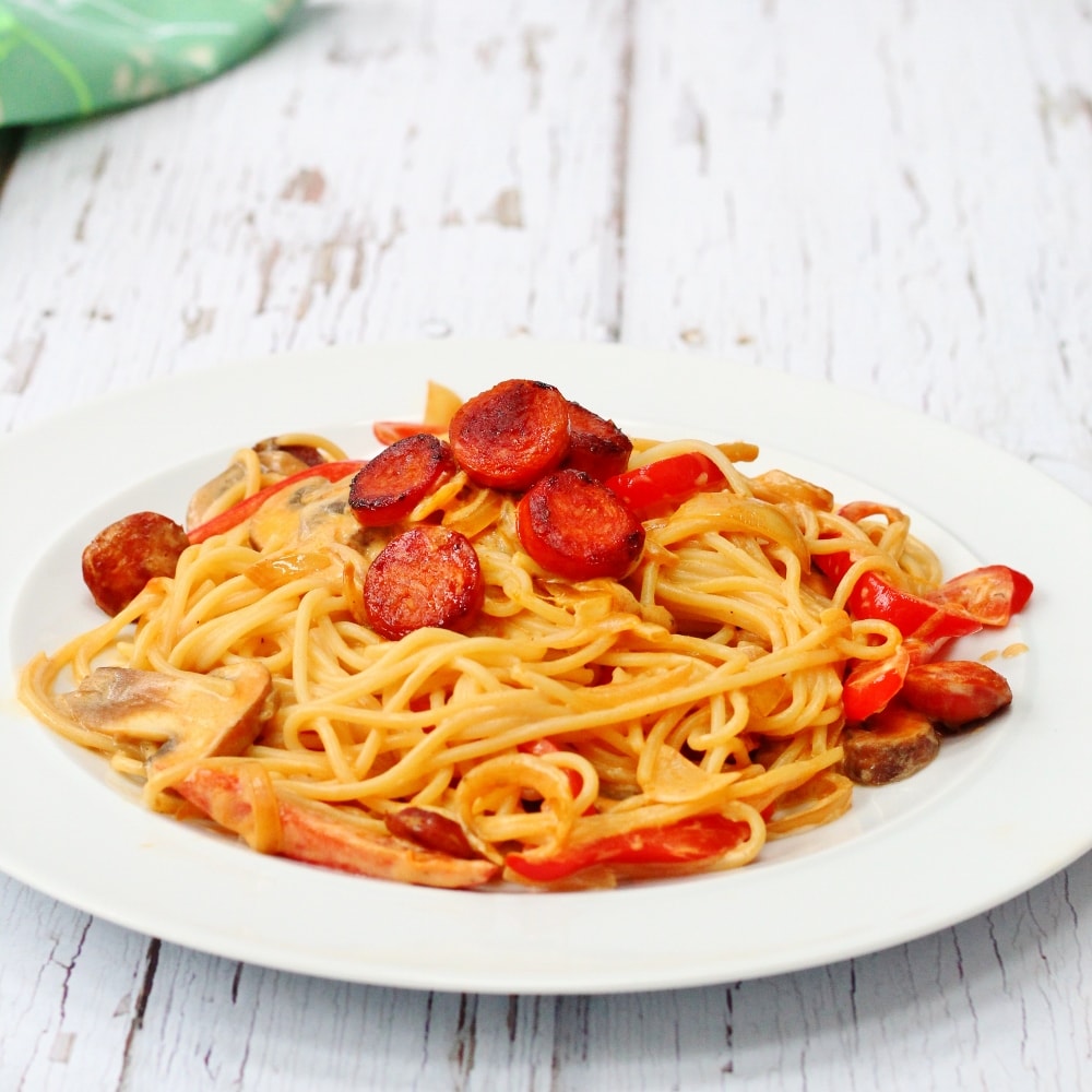 white plate with chorizo pasta;