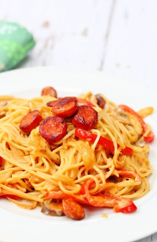 Spaghetti topped with crispy pieces of chorizo in a creamy sauce