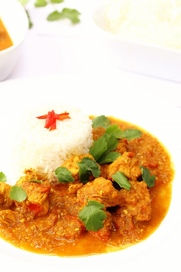 Burmese chicken curry on a plate with ricce