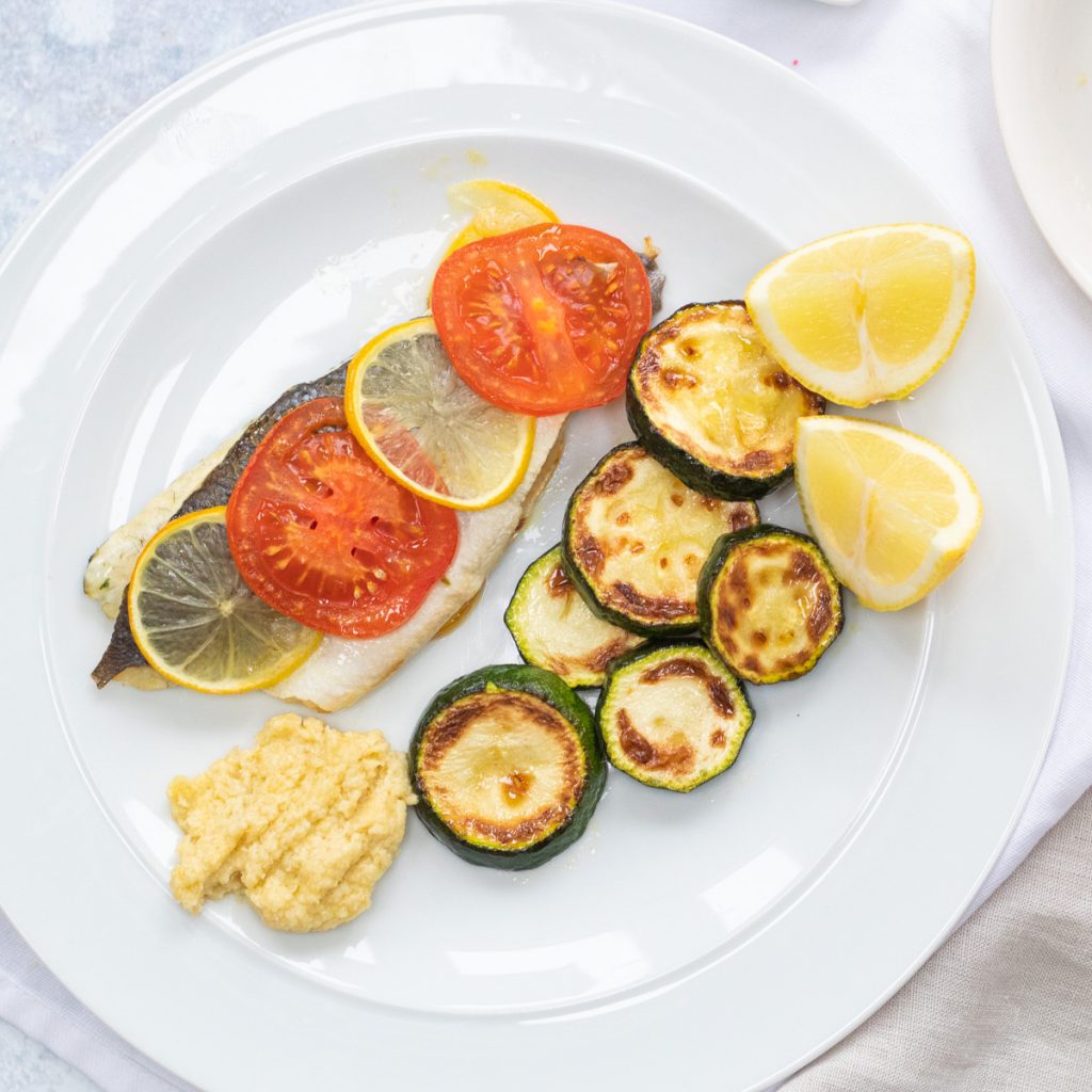 plate of sea bass with tarator sauce and courgettes