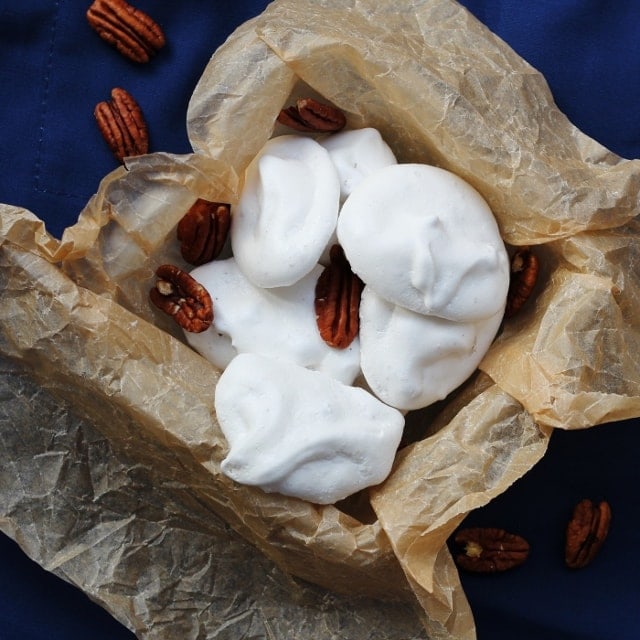 Pecan meringues on a blue background