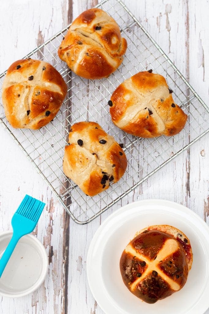 flatlay of hot cross buns cooling on a wire rack