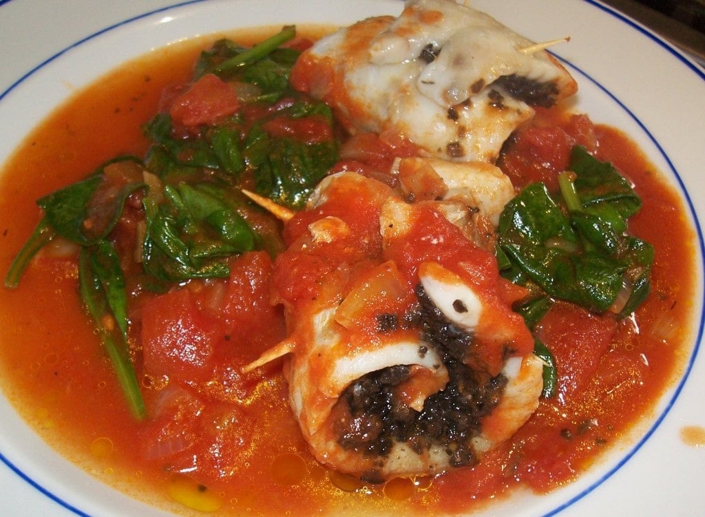 Fish with spinach olives and tomatoes