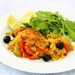 Puerto rican chicken: chicken, olives and peppers cooked in spicy rice on a plate