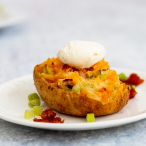 jacket potato skin stuffed with onions, bacon and cheese