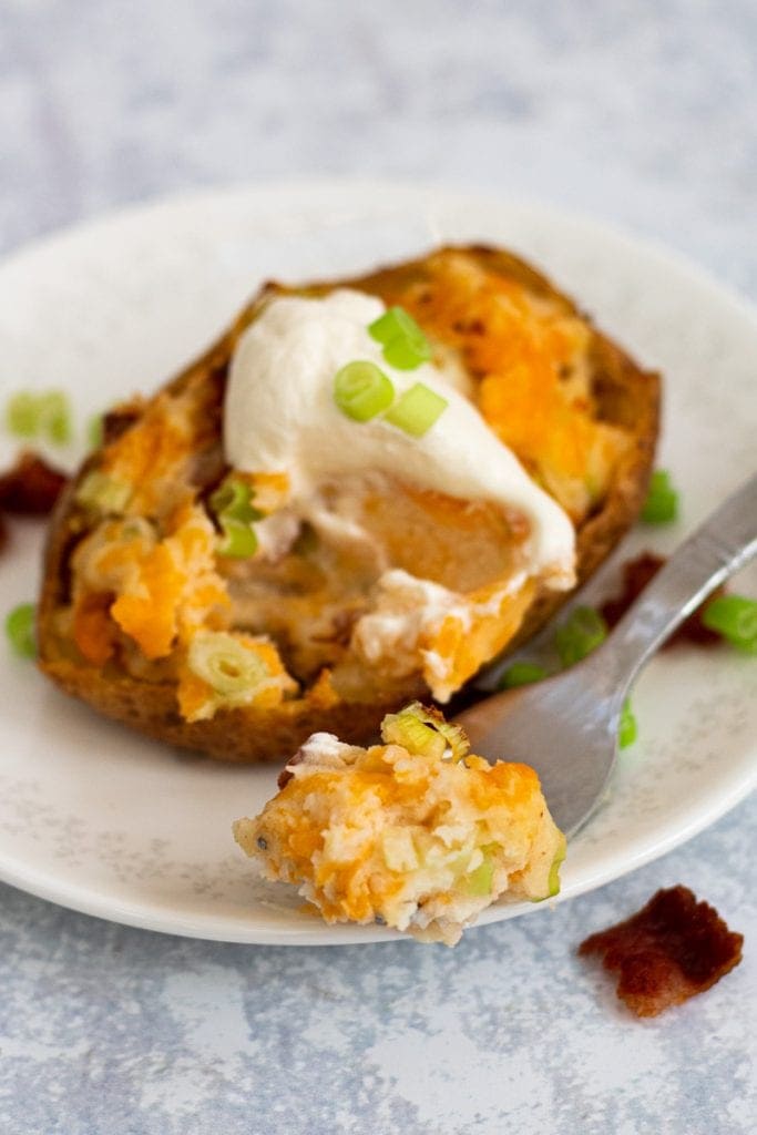 stuffed jacket potato with a fork with potato on