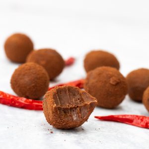 Chocolate truffles with chilli and one with a bite taken out