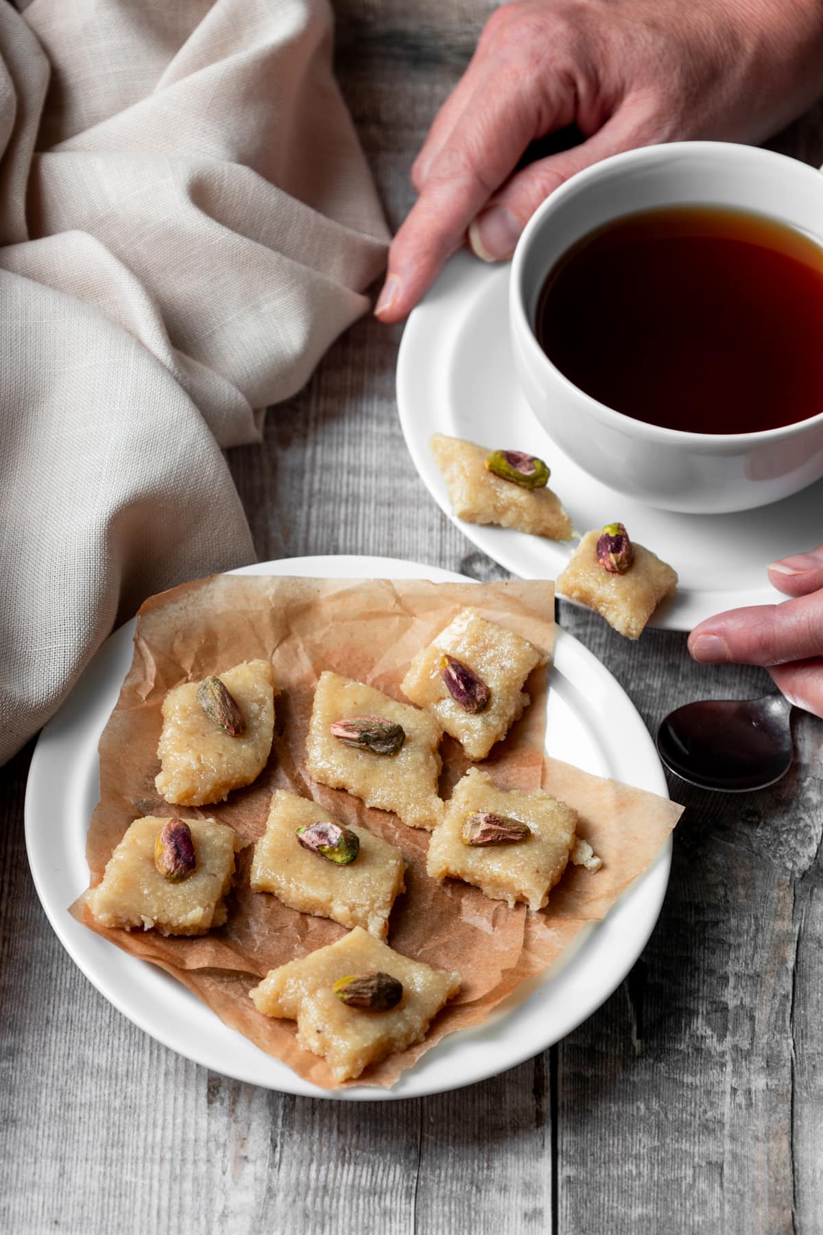 Cup of tea and plate of Indian cashew fudge