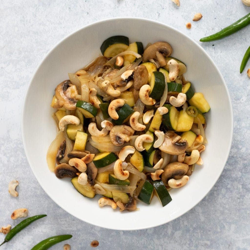 courgette and mushroom stir fry in a white bowl