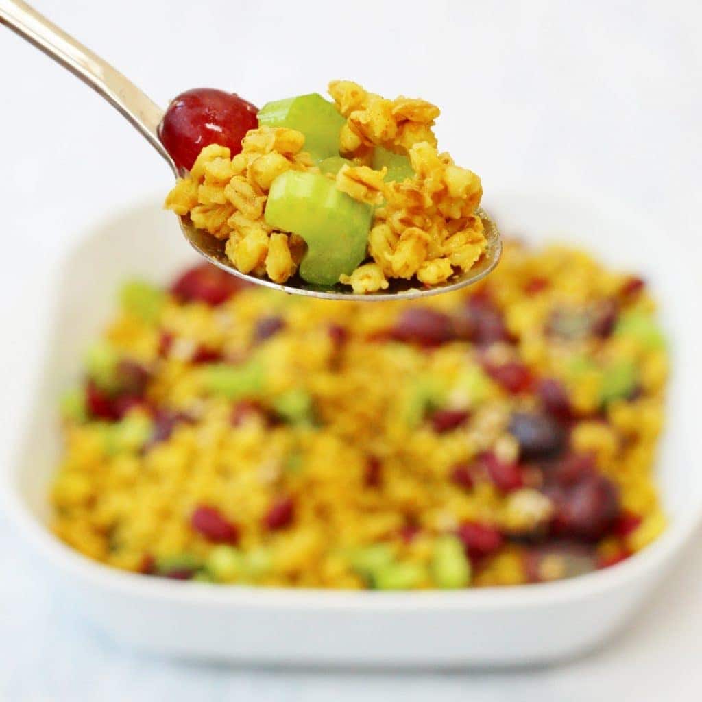 Bowl of curried pearl barley salad in the background with a spoonful of barley