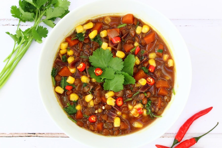 Healthy soup with green lentils, sweetcorn, carrots, chilli and coriander
