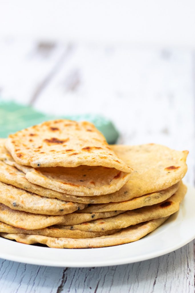 nigella seed flatbreads in a stack with one folded in half