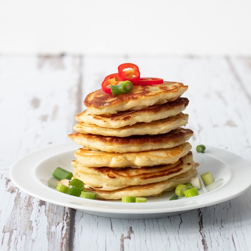 stack of sweetcorn fritters with spring onion and chilli