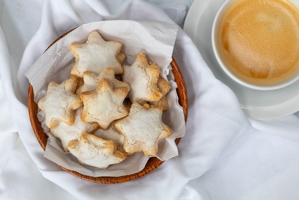cinnamon star biscuit in a bowl with coffee