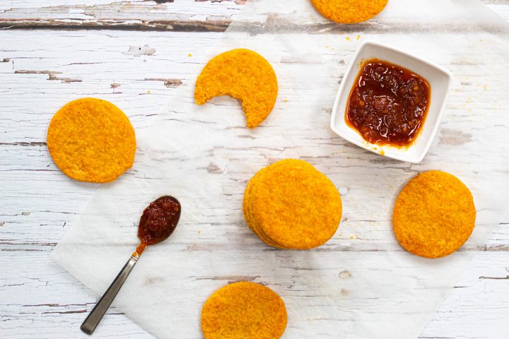 flatlay of cheesy homemade crackers and chilli jam