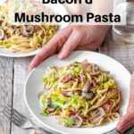 Plate of creamy bacon leek mushrom pasta with hands pin image
