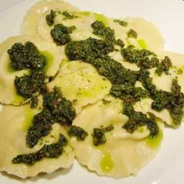 sun dried tomato ravioli with mozzarella and basil and a pesto sauce