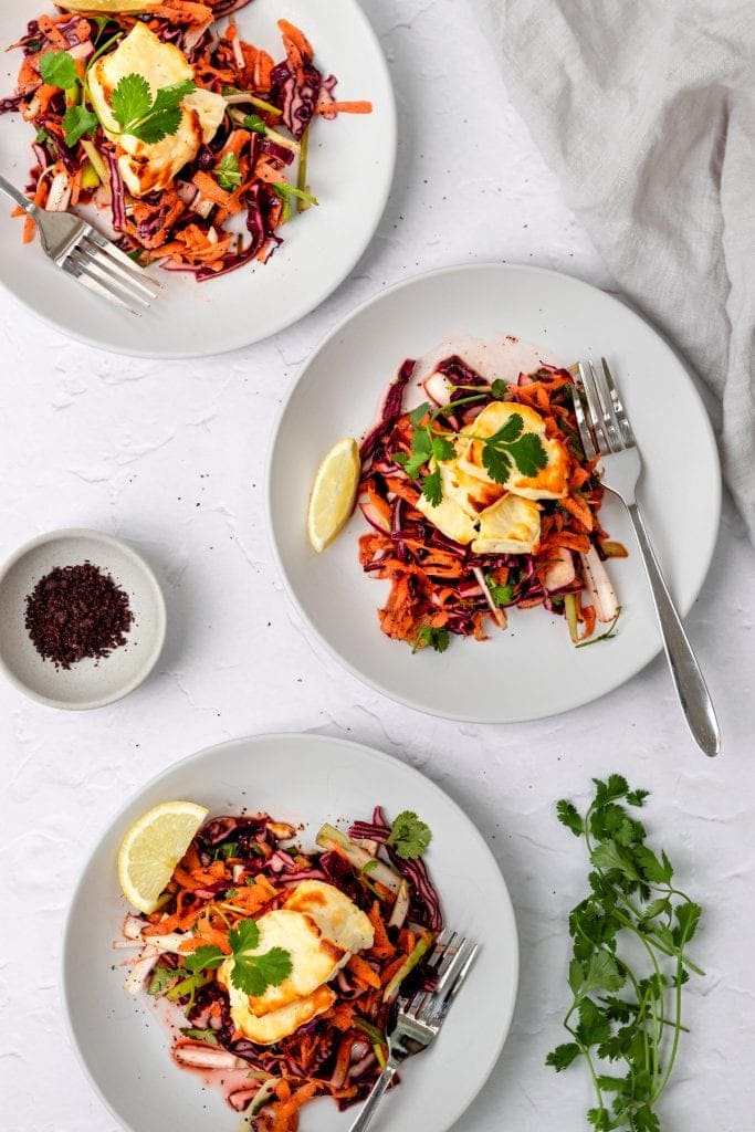 3 plates of halloumi salad with pomegranate molasses dressing