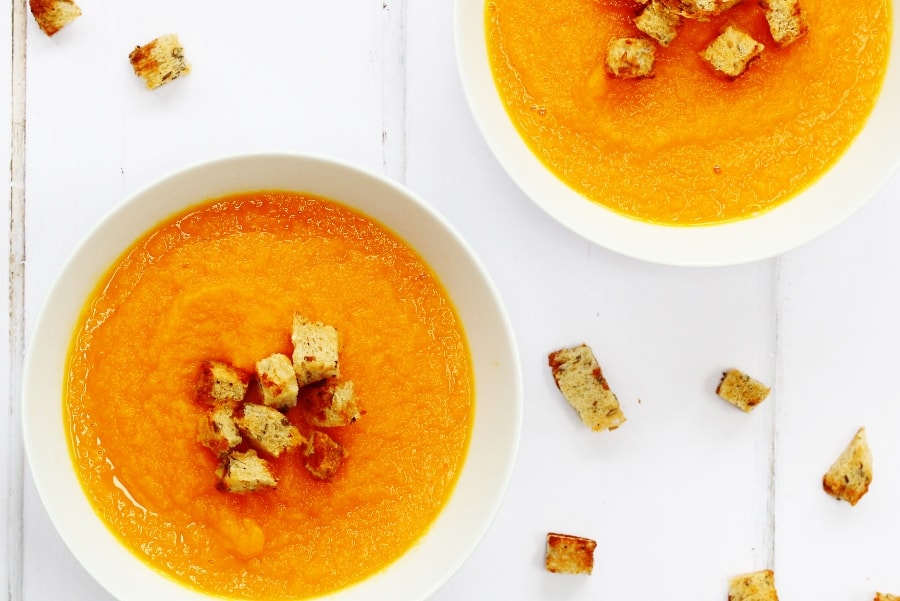 Two bowls of carrot and ginger soup 