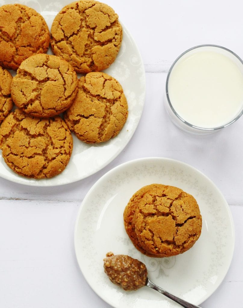 Peanut butter cookies on a plate from above with a glass of milk