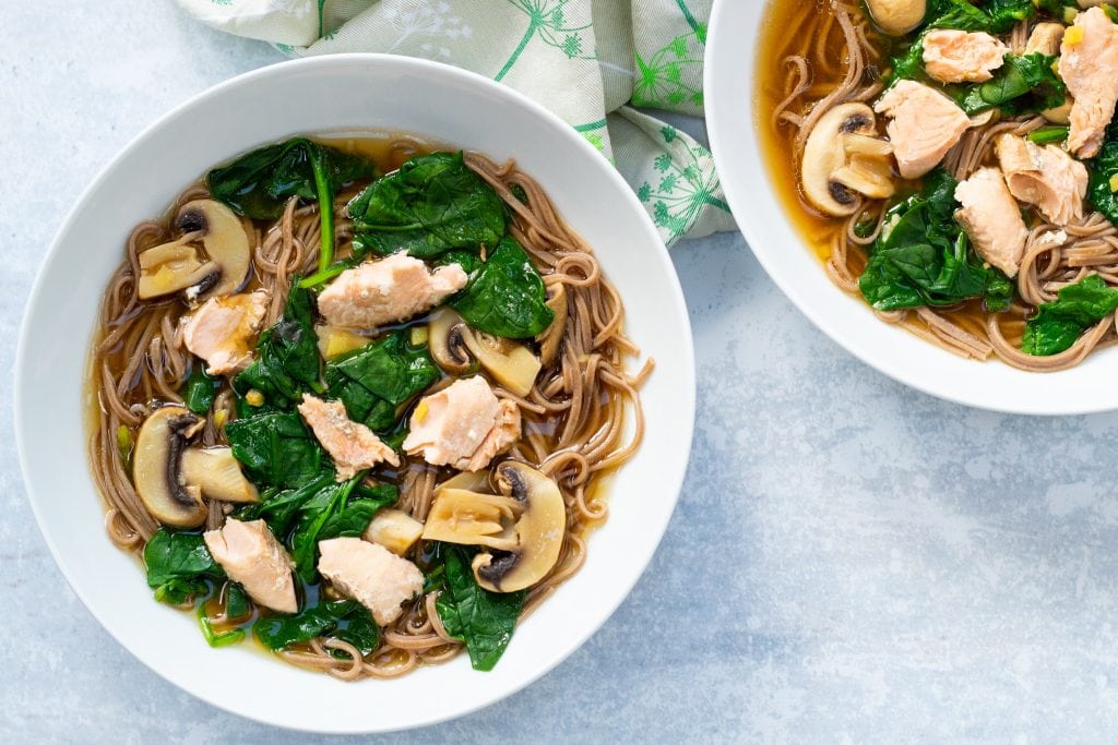 two bowls of salmon miso soup with soba noodles