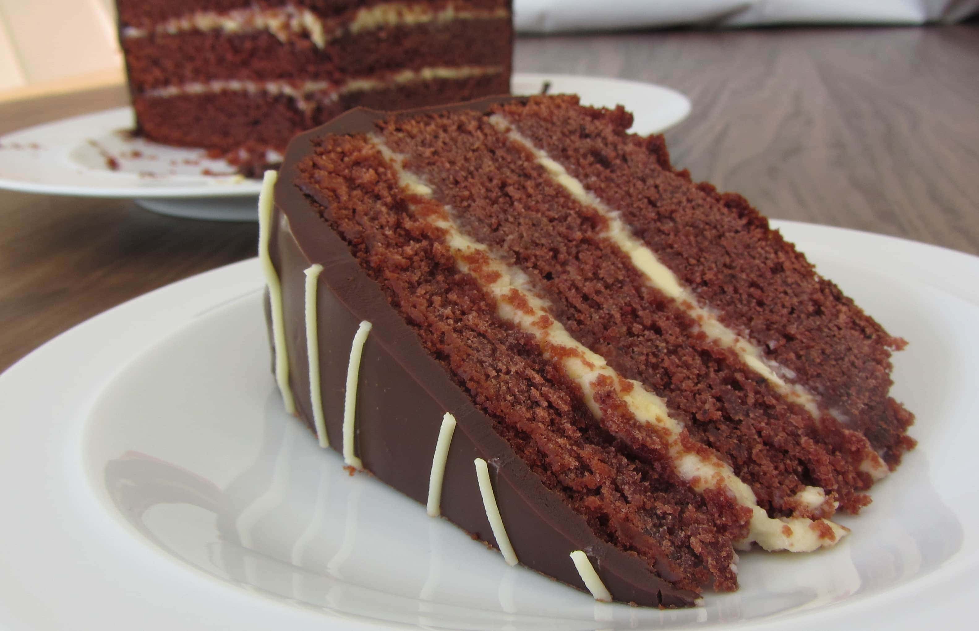 Red velvet halloween cake with cream cheese icing and chocolate ganache coating