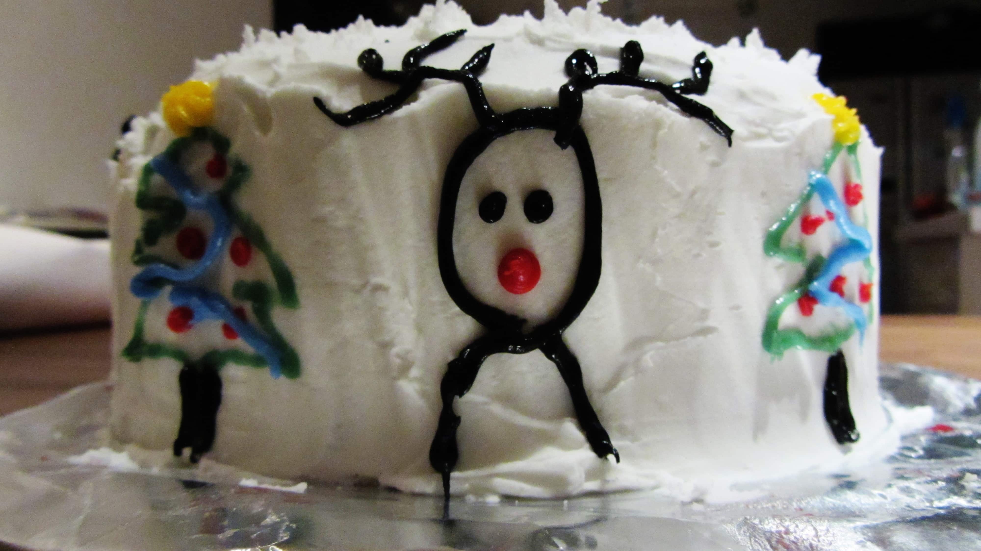 Side of Christmas cake with rudolph and christmas tree design