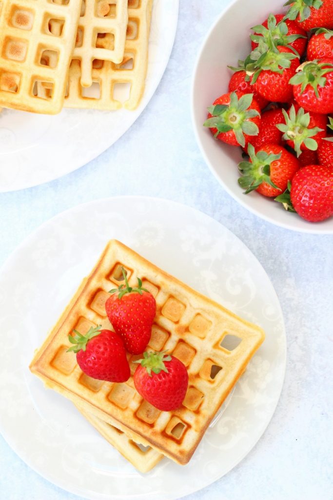 flatlay picture of homemade waffles topped with strawberries