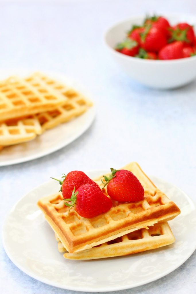 Homemade plain traditional waffles for breakfast with strawberries