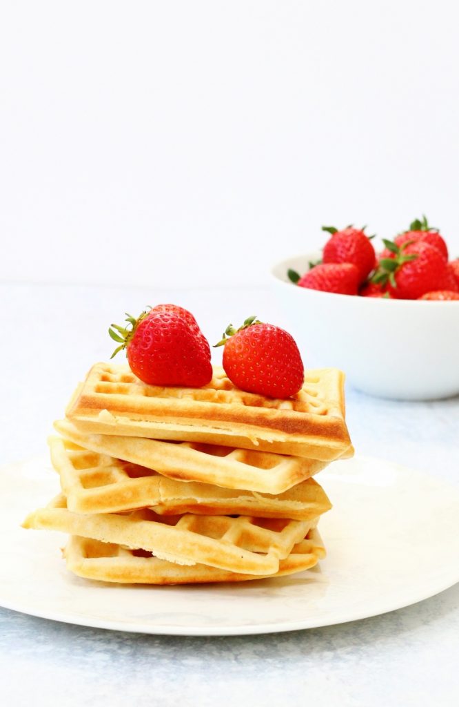 Stack of waffles topped with strawberries