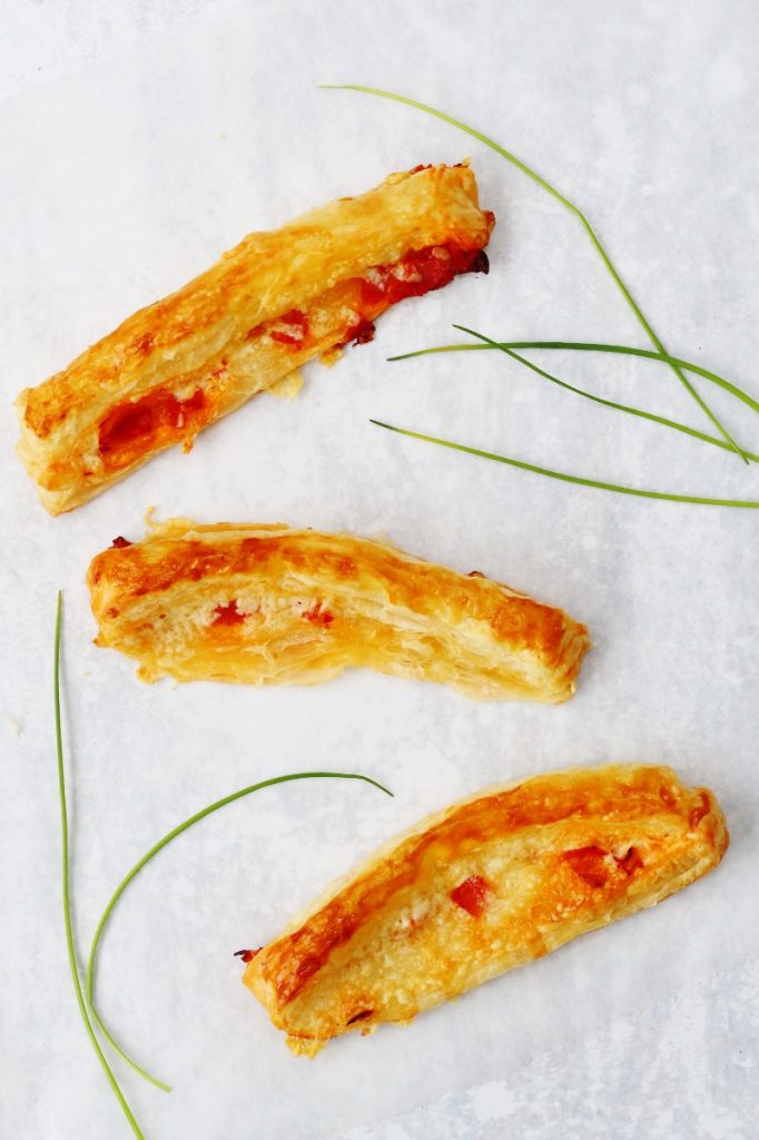 flatlay of 3 chorizo and cheese straws with a few chives