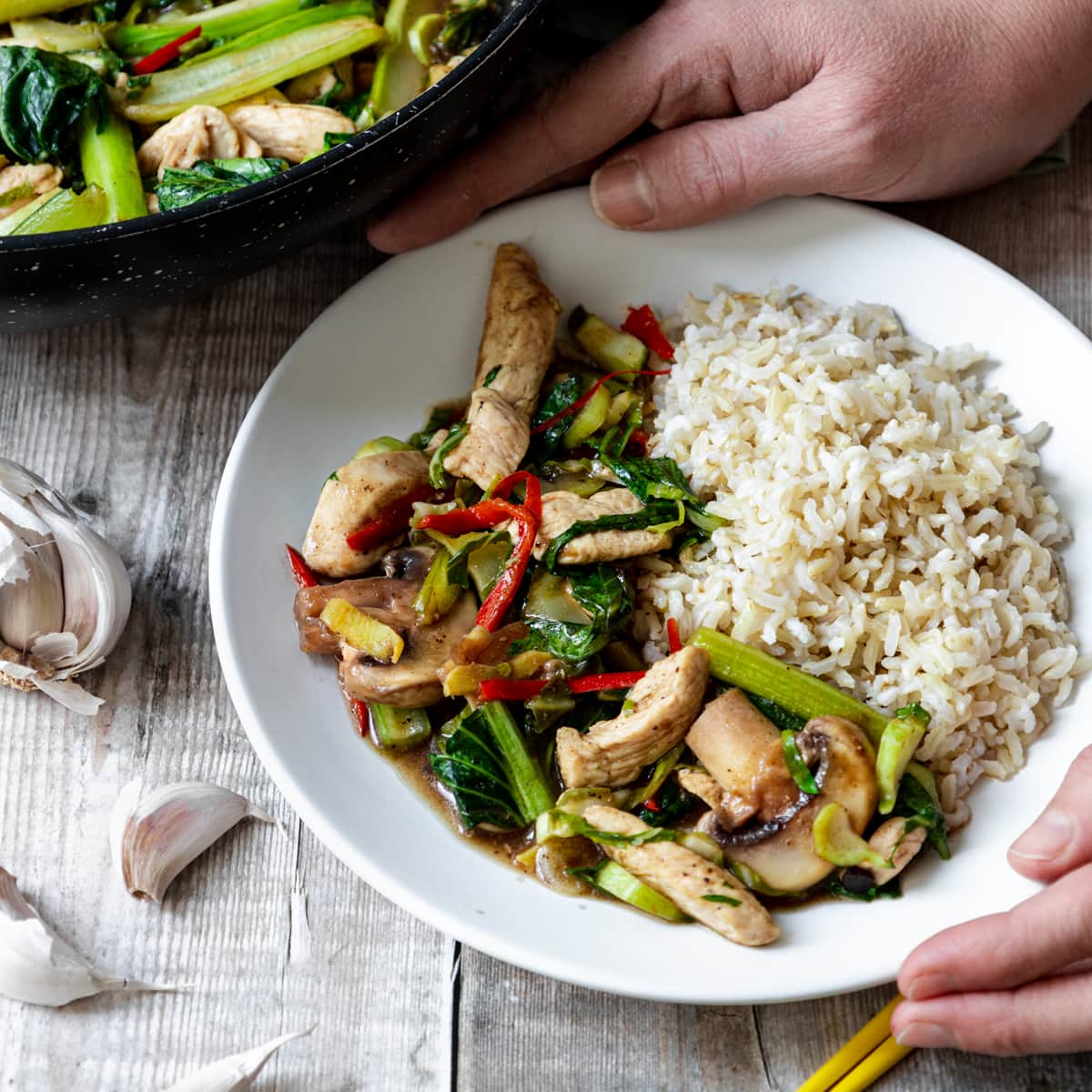 plate of cauliflower leaves and chicken stir fry