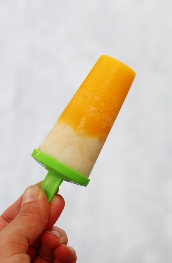 close up of one peach and banana layered ice lolly