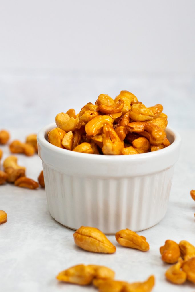 Honey roasted cashew nuts in a white ramekin