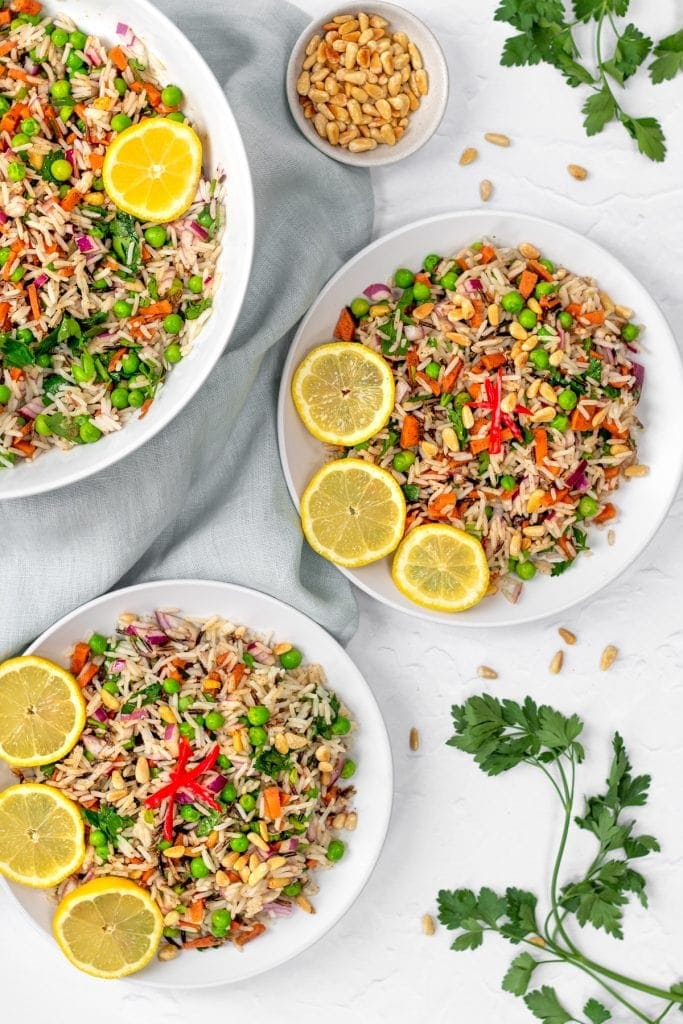 bowls of rice and pea salad with lemon slices