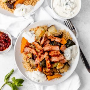 Plate of couscous, lamb and roasted vegetable salad