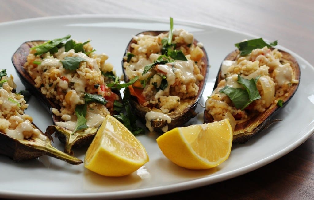 couscous stuffed aubergine  drizzled with tahini sauce