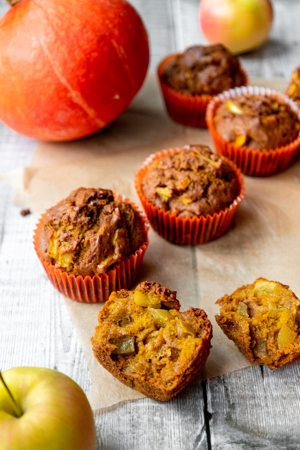 pumpkin and apple muffins with pumpkin in background
