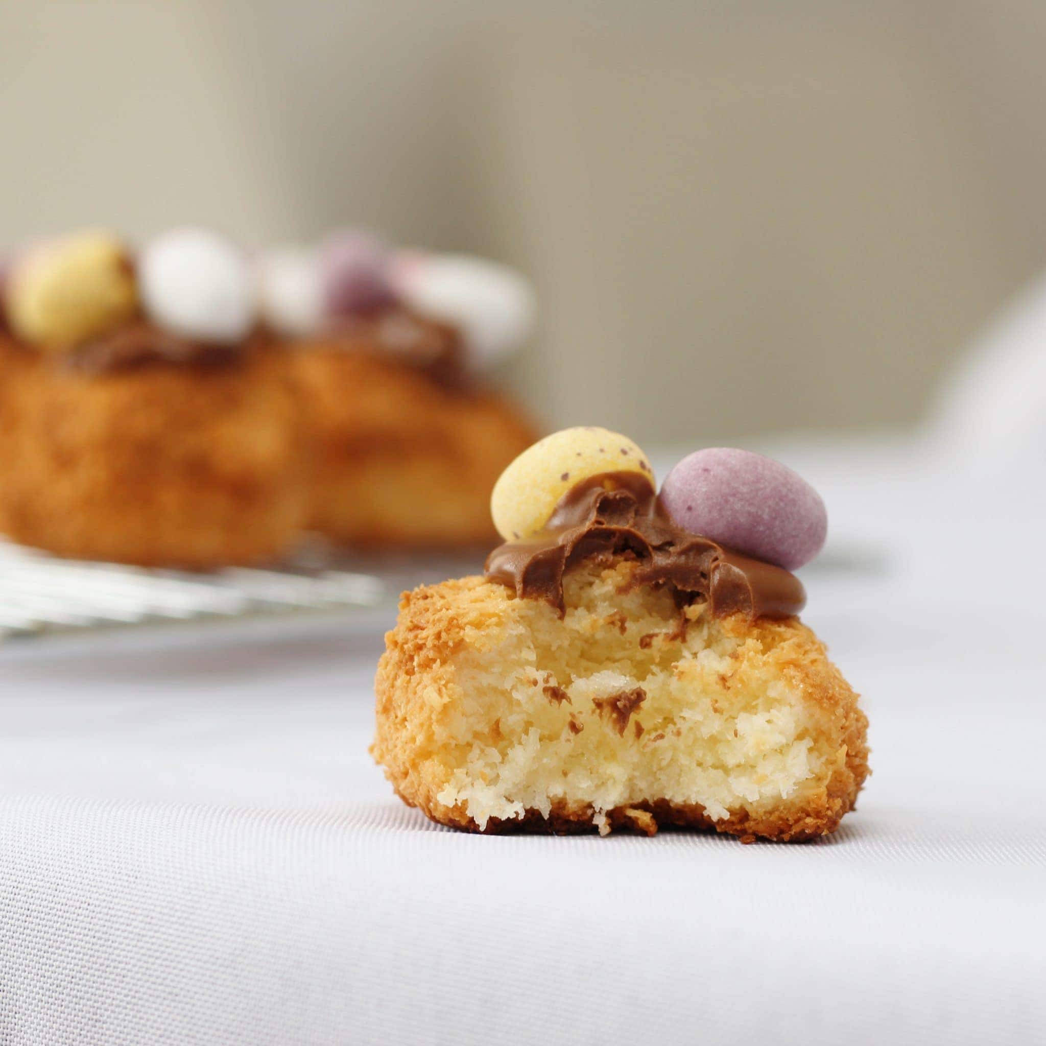Coconut Macaroons topped with melted chocolate and mini eggs. An easy Easter bake