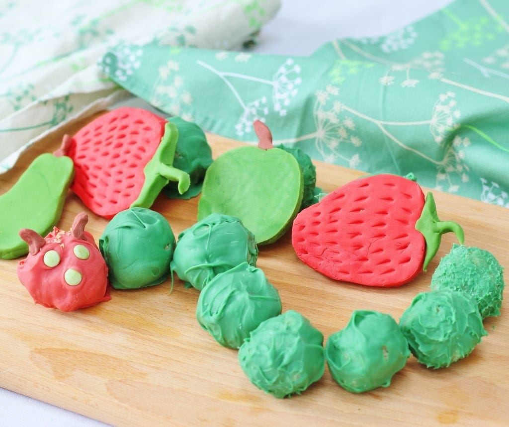 Hungry caterpiller cake balls with fondant icing fruits