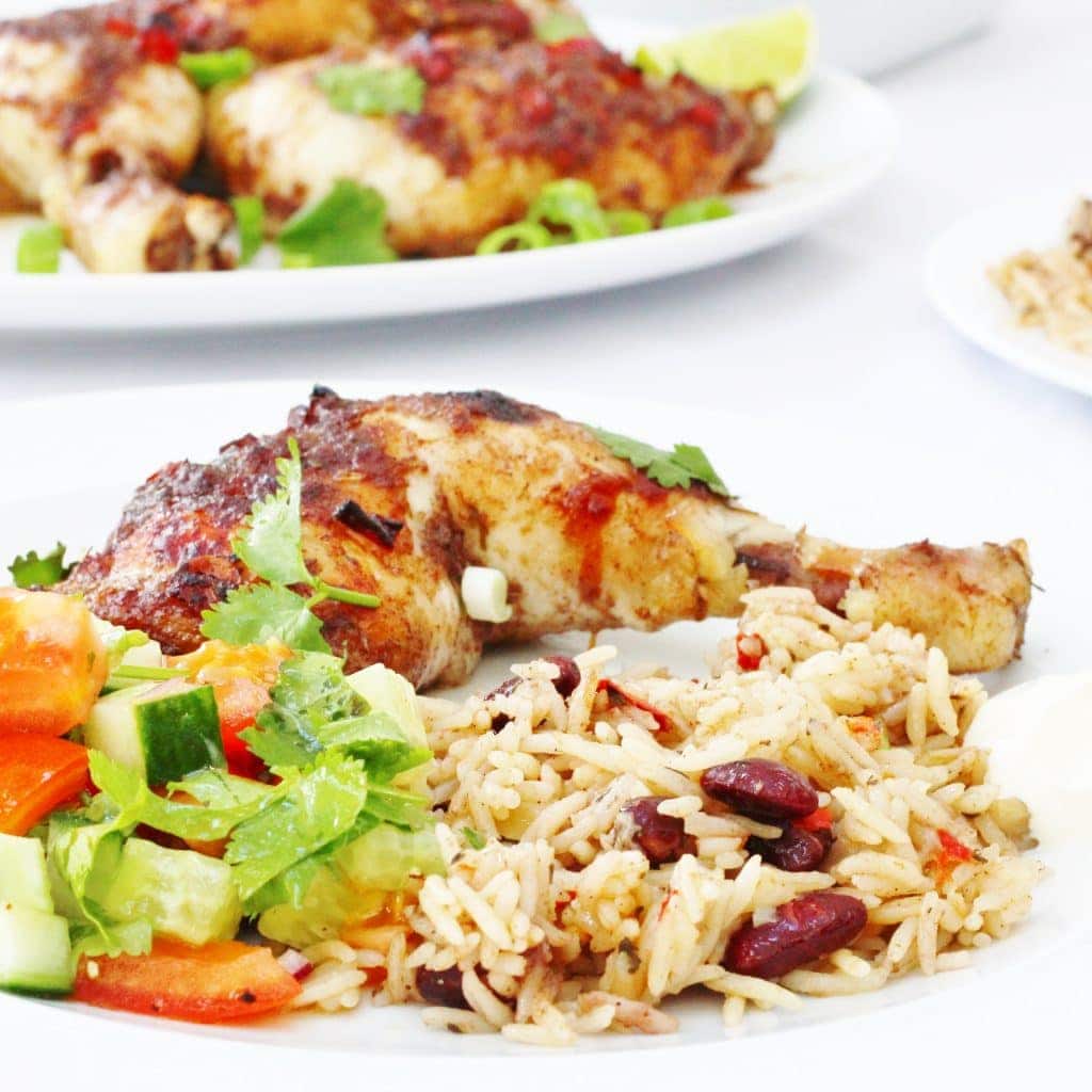 jerk chicken leg with rice and peas