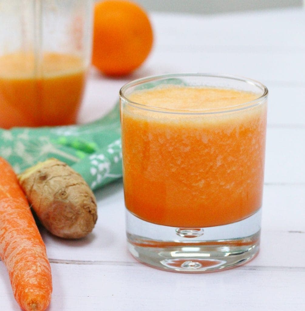 Orange smoothie with carrot and ginger in a glass