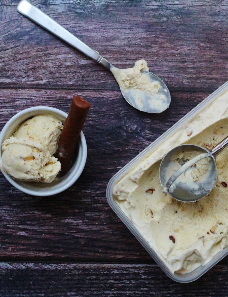 banana fudge ice cream in a tub, bowl and spoon