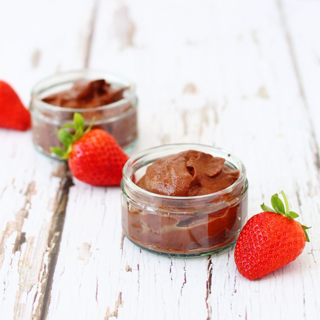 two pots of homemade chocolate cauliflower pudding with strawberries