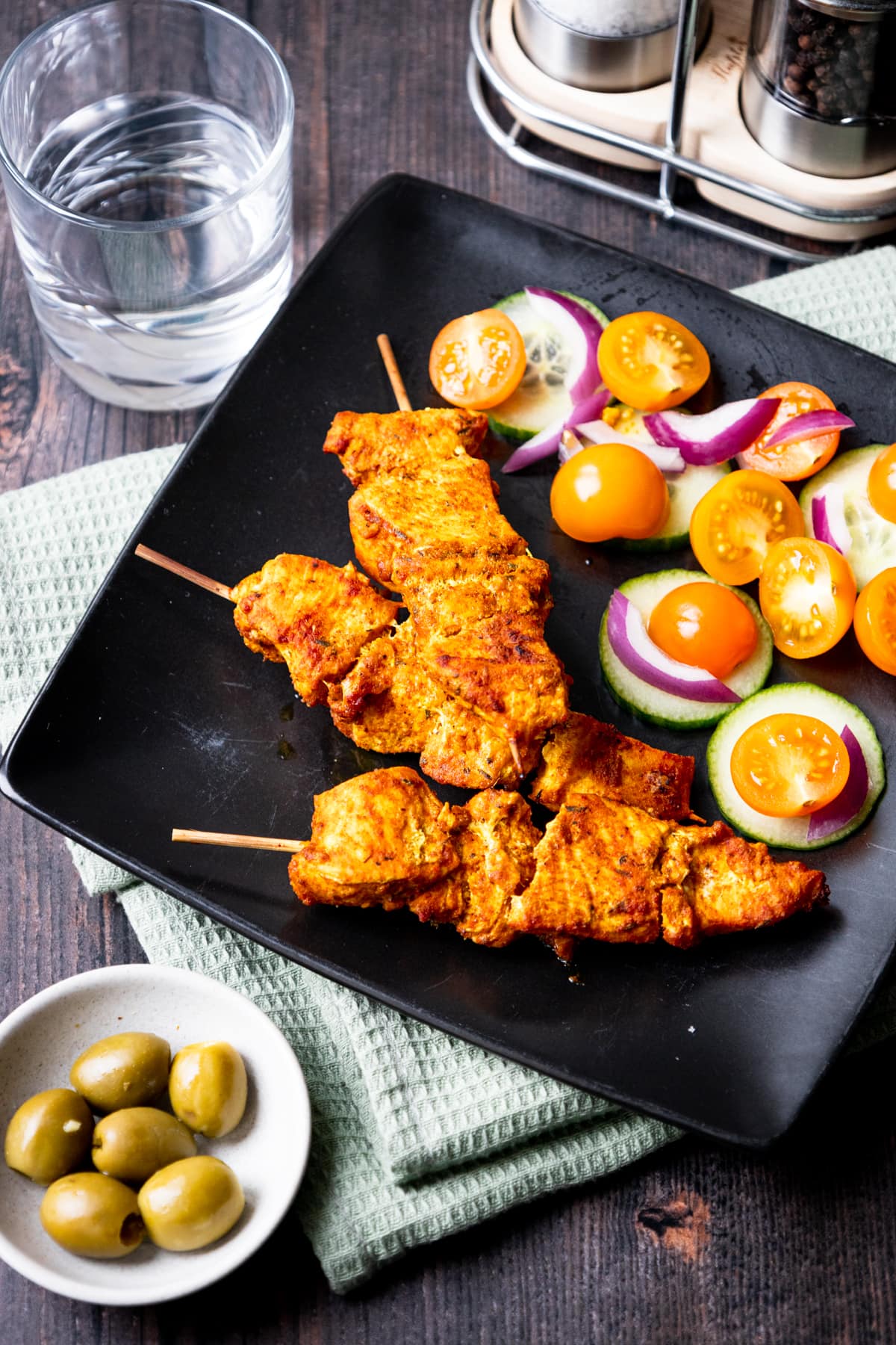 Spanish chicken kebabs with salad and olives