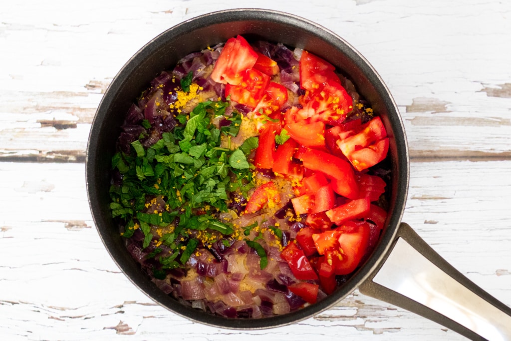 couscous in a pan with tomatoes, mint and lemon zest