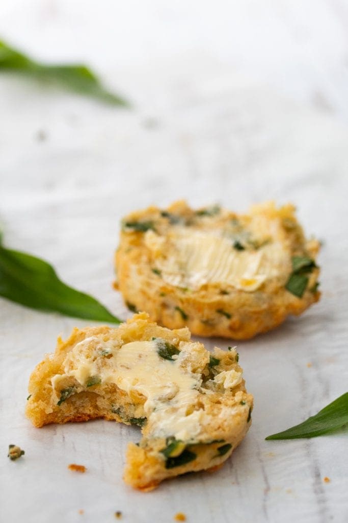 Cheesy wild garlic scone cut in half with butter on the top