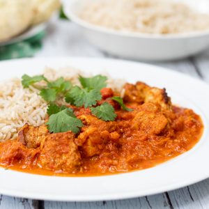 chicken tikka masala on a plate with rice